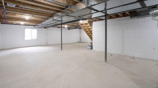 Image of a basement interior showcasing freshly applied crystalline waterproofing coating on concrete walls and floor, creating a sleek, impermeable surface designed to protect against water ingress and ensure structural integrity.